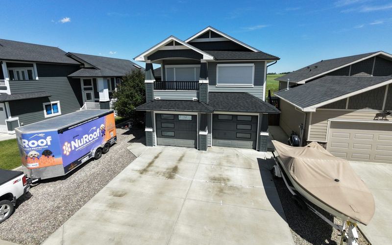 Concrete driveway at an East Kootenay home with the Key City trailer parked beside it