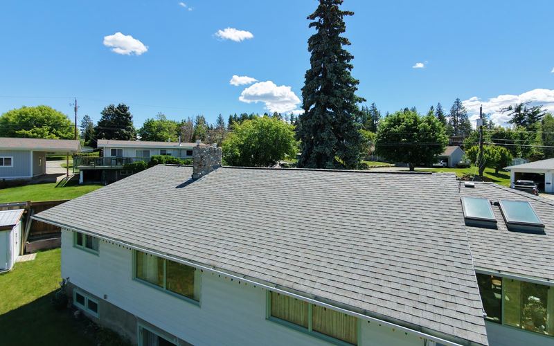 Drone photo of a grey shingle roof on an East Kootenay home in early fall