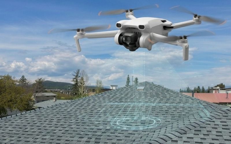 Drone inspecting a shingle roof during a roof assessment